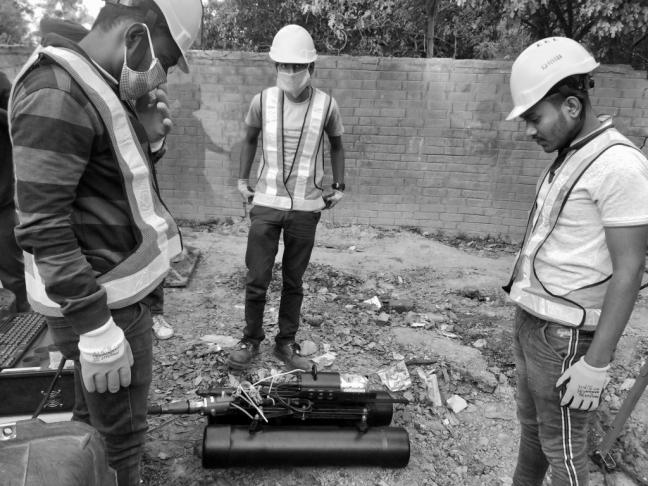 Fluid Robotics employees with robot during deployment. Photo by: Asim Bhalerao Fluid Robotics employees with robot during deployment