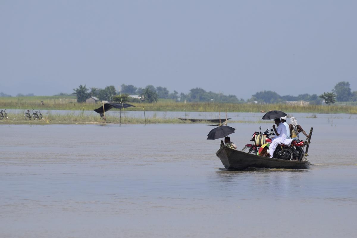 Char residents crossing the river with their motorbikes.